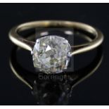 A gold and old mine cut solitaire diamond ring, the stone measuring approximately 8.5mm by 8.3mm,