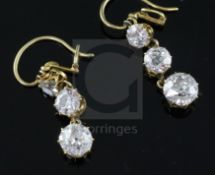 A pair of gold and graduated three stone diamond set drop earrings, the largest stone on each drop