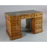 A Victorian walnut pedestal desk, with gilt green skiver and nine drawers fitted Bramah locks, W.4ft