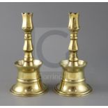 A pair of 17th century Ottoman brass bell based candlesticks, H.9in.