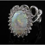 A modern 18ct white gold, white opal and diamond oval cluster ring, with unusual 'six ring' shank,