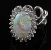 A modern 18ct white gold, white opal and diamond oval cluster ring, with unusual 'six ring' shank,