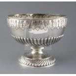 A Victorian demi-fluted silver pedestal punch bowl by Martin, Hall & Co, embossed with acanthus leaf
