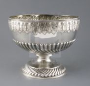 A Victorian demi-fluted silver pedestal punch bowl by Martin, Hall & Co, embossed with acanthus leaf