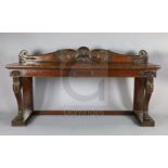 A Regency mahogany serving table, with scroll and scallop carved raised back and two frieze drawers,