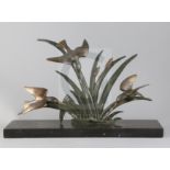 G. Limousin. A French Art Deco bronze group of three kingfishers flying amongst bulrushes, on