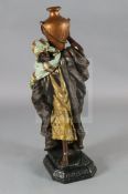 A Goldscheider style painted plaster figure of an Arab water carrier, H.40in.