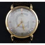 A gentleman's late 1940's 18ct gold Omega automatic wrist watch, the silvered dial with baton and