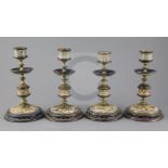 Frank A Butler for Doulton Lambeth, a set of four brass mounted candlesticks, c.1890, each incised