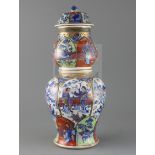 A large Chinese clobbered blue and white double gourd vase and cover, Kangxi period, painted with