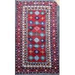 A Lambalo Kazak Caucasian small carpet, the red field woven with three rows of stylised floral
