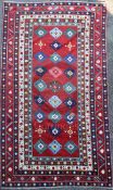 A Lambalo Kazak Caucasian small carpet, the red field woven with three rows of stylised floral