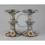 Edith D Lupton for Doulton, a pair of monogrammed candlesticks, dated 1879, each incised with