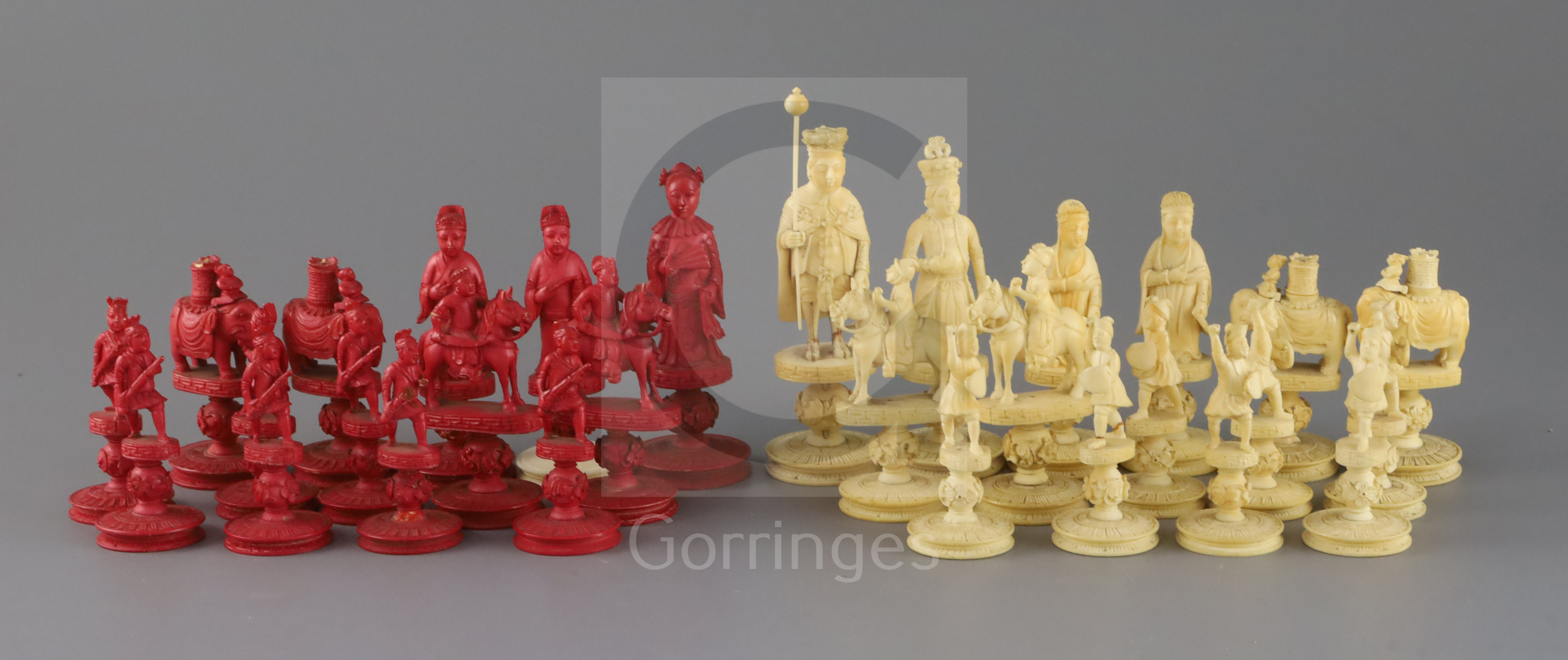 An early 19th century Chinese red stained and natural ivory 'rosette' type chess set, modelled as