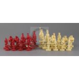 An early 19th century Chinese red stained and natural ivory 'rosette' type chess set, modelled as