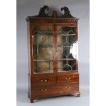 A George III mahogany display cabinet, with blind fret carved swan neck pediment and two astragal