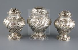 A pair of George II embossed silver tea caddies and a matching sugar box, Samuel Taylor, of inverted