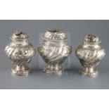 A pair of George II embossed silver tea caddies and a matching sugar box, Samuel Taylor, of inverted