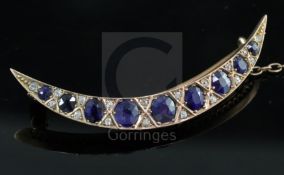 An Edwardian gold, graduated sapphire and rose cut diamond set crescent brooch, 5cm.