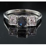 A 1930's platinum, sapphire and diamond three stone ring, with oval cut sapphire and round cut