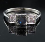A 1930's platinum, sapphire and diamond three stone ring, with oval cut sapphire and round cut