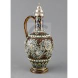 George Tinworth for Doulton Lambeth, a scroll and flowerhead design silver-topped ewer, dated