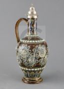 George Tinworth for Doulton Lambeth, a scroll and flowerhead design silver-topped ewer, dated