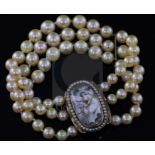 A triple strand cultured bracelet, now with a Regency gold mounted oval panel mourning clasp,