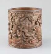 A Chinese bamboo 'eighteen luohan' brush pot, late Qing dynasty, the exterior carved in high