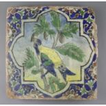 A large Persian 'parrot' tile, Qajar dynasty, painted in colours to a octafoil reserve within