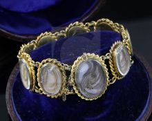 A cased Victorian gold and glazed plaited hair oval panel family memento bracelet, comprising nine