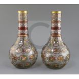 A pair of Bohemian Ottoman Market glass bottle vases, late 19th century, each enamelled and ruby