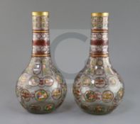 A pair of Bohemian Ottoman Market glass bottle vases, late 19th century, each enamelled and ruby