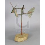 An American? painted wrought iron whirligig, on tree trunk plinth, H.39in.