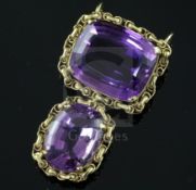 A gold and two stone amethyst set drop pendant, the oval cushion and round cut stones with ornate