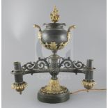 A William IV table top bronze double light Colza lamp, the burners held by cast dog heads on each