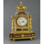 A 19th century French Louis XVI style ormolu and red marble mantel clock, the architectural case