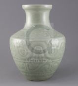 A Chinese celadon glazed archaistic moulded vase, Qianlong underglaze blue seal mark to base,