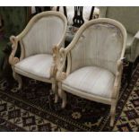 A pair of French swan empire armchairs