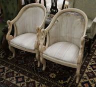 A pair of French swan empire armchairs