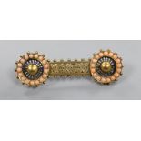 A late Victorian pierced yellow metal and coral bead set 'double wheel' bar brooch, 54mm.