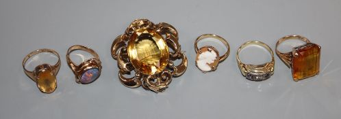 Three 9ct and gem set rings, one 585 gem set ring, one other yellow metal ring and a yellow metal