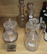 A pair of cut glass decanters, a jug, a silver-mounted Georgian honey jar and cover and later etched