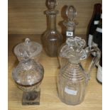 A pair of cut glass decanters, a jug, a silver-mounted Georgian honey jar and cover and later etched