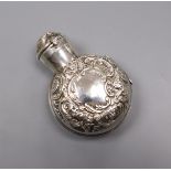 A late Victorian glass scent bottle with repousse silver hinged case, by William Comyns, London,