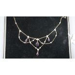 A 375 yellow metal, cabochon amethyst and seed pearl set drop necklace, 62cm.