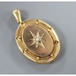 A Victorian yellow metal and seed pearl set oval locket, locket 43mm.