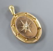 A Victorian yellow metal and seed pearl set oval locket, locket 43mm.