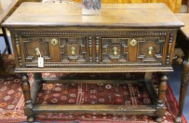 A 17th century style oak dresser base, with beaded and geometric moulded drawers, on turned legs