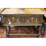 A 17th century style oak dresser base, with beaded and geometric moulded drawers, on turned legs